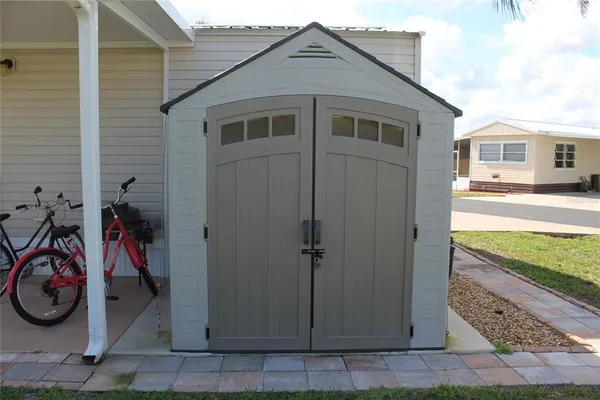 a view of a house with a yard and a car