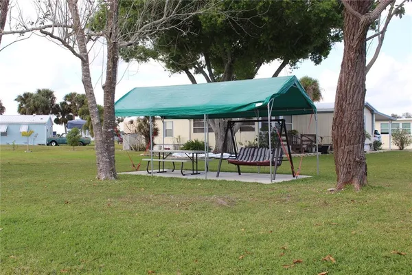 a view of a table and chairs under an umbrella