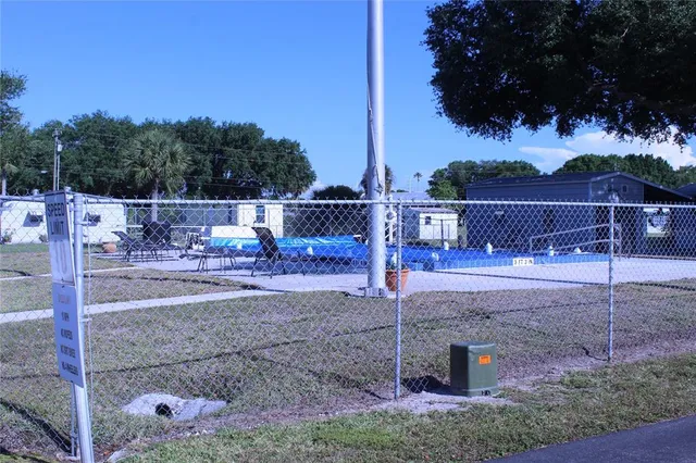 a view of a park with iron fence