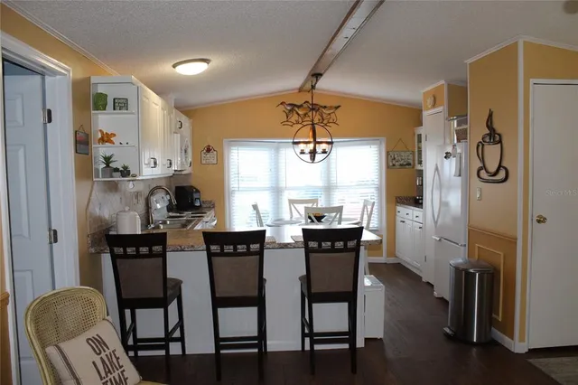 a view of a dining room with furniture and window