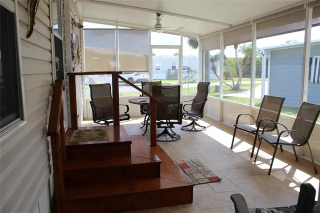 a living room with furniture and a floor to ceiling window