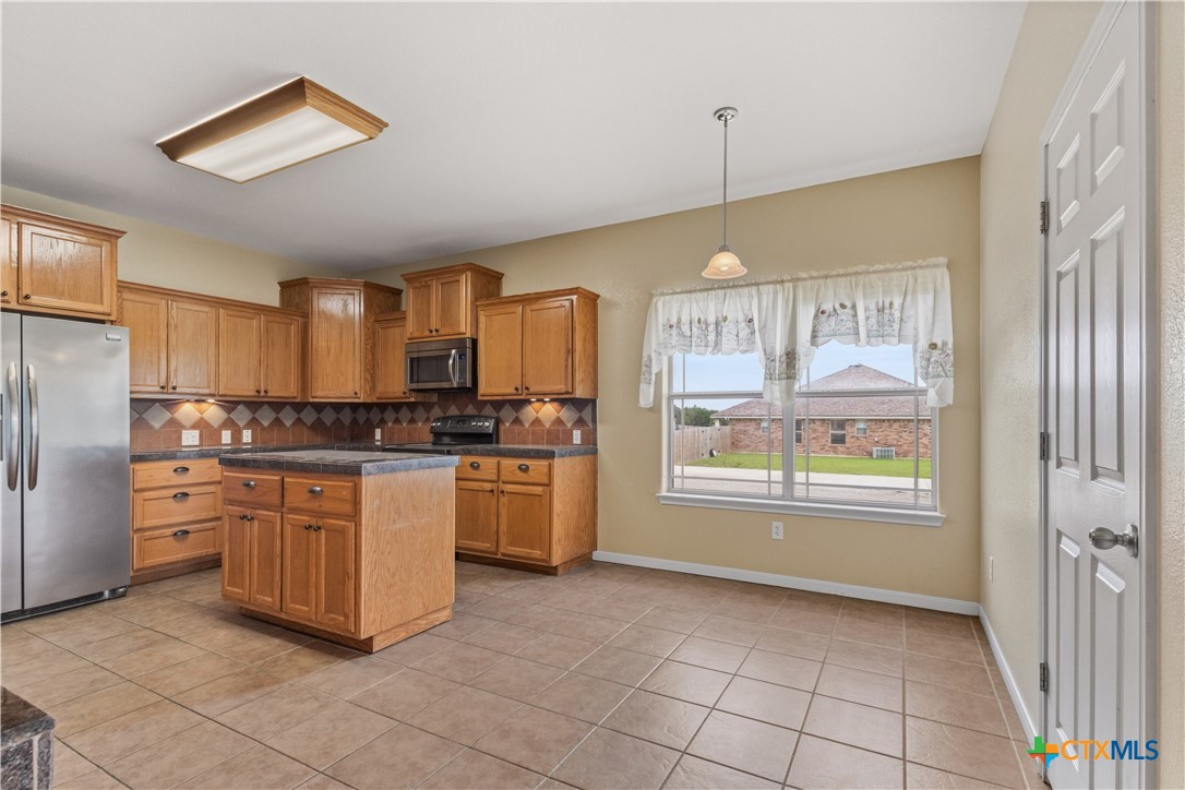 283 County Road 4710 Kempner, TX 76539 - Photo 14 of 47 a kitchen that has a lot of cabinets and stainless steel appliances