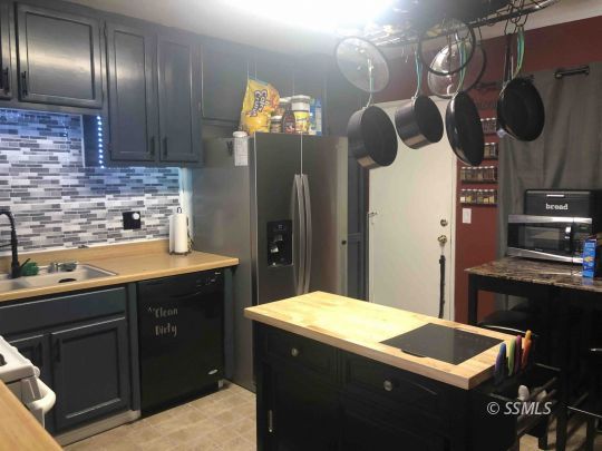125 South Broadway Street Ridgecrest, CA 93555 - Photo 8 of 24 a kitchen with cabinets and stainless steel appliances