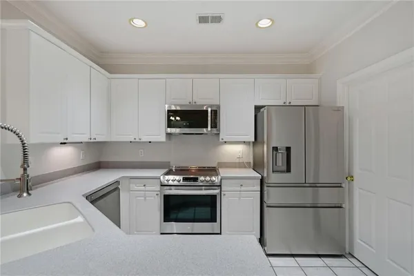 a kitchen with a refrigerator sink and microwave