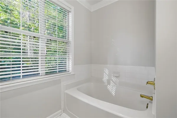 a white bath tub sitting next to a window