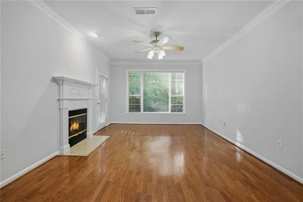 a view of an empty room with a fireplace and a window