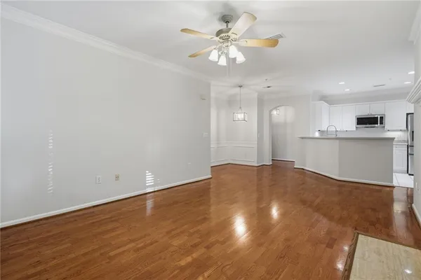 a view of a kitchen with a sink and a chandelier fan