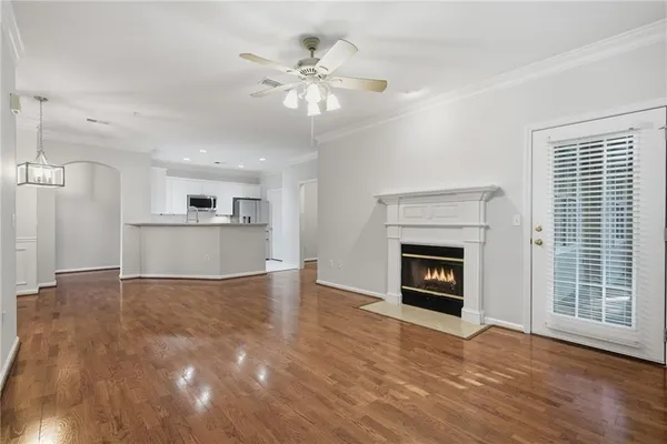 a view of an empty room with a fireplace and a window