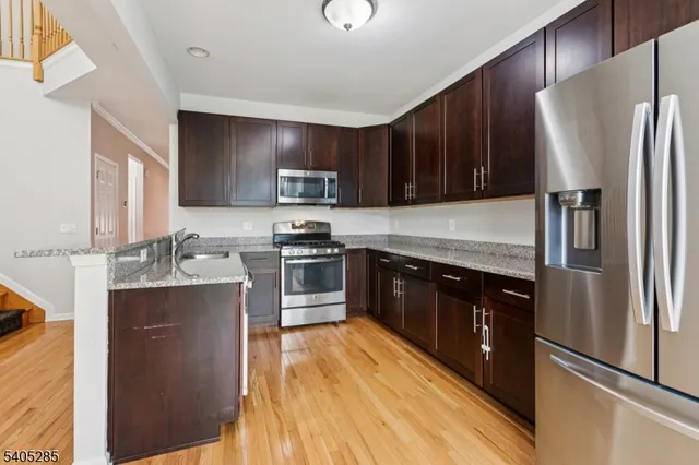 a kitchen with stainless steel appliances a refrigerator stove and sink