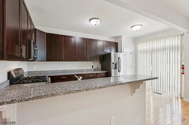a kitchen with granite countertop a sink and a stove top oven