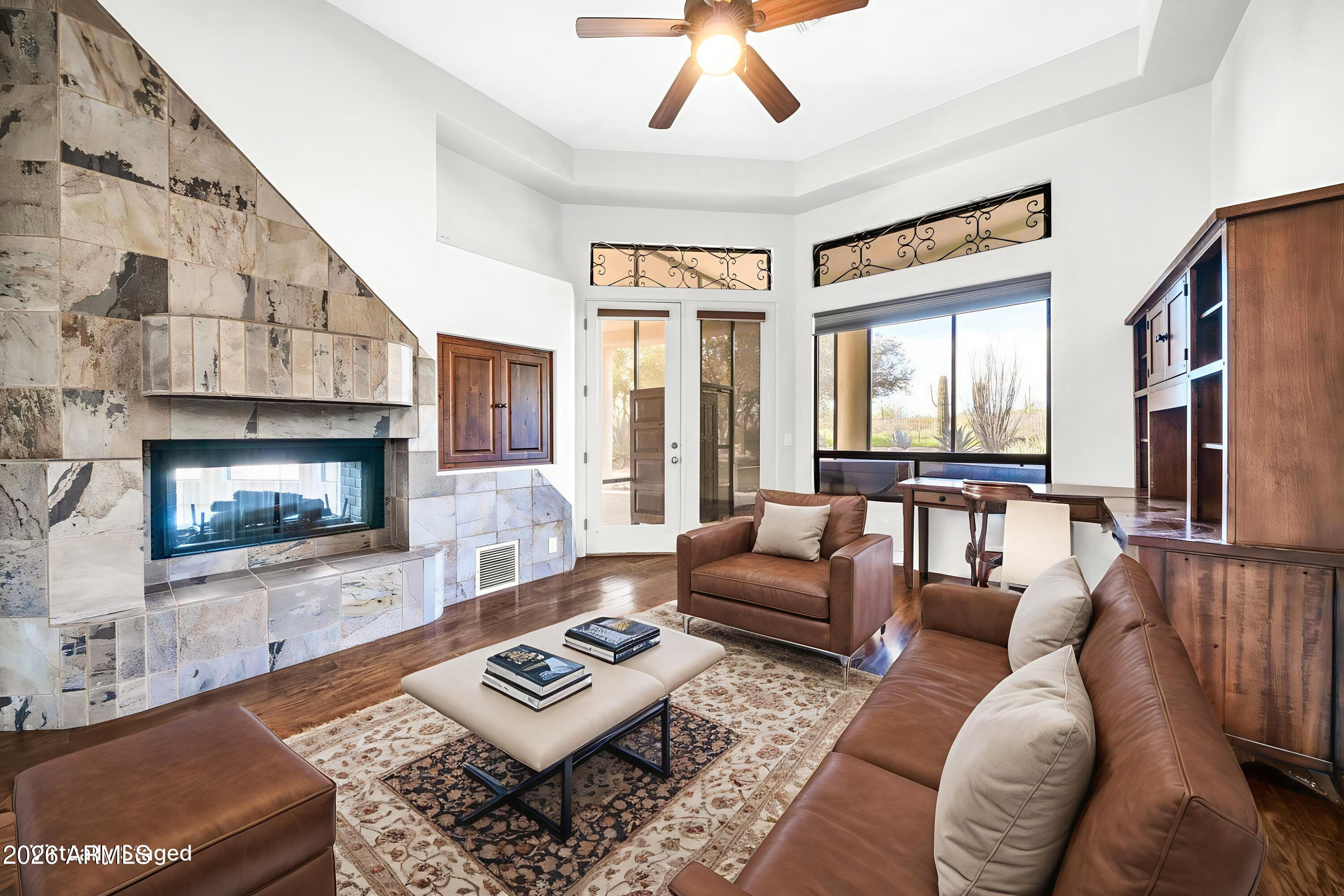 27902 North Agua Verde Drive Rio Verde, AZ 85263 - Photo 24 of 62 a living room with furniture and a fireplace