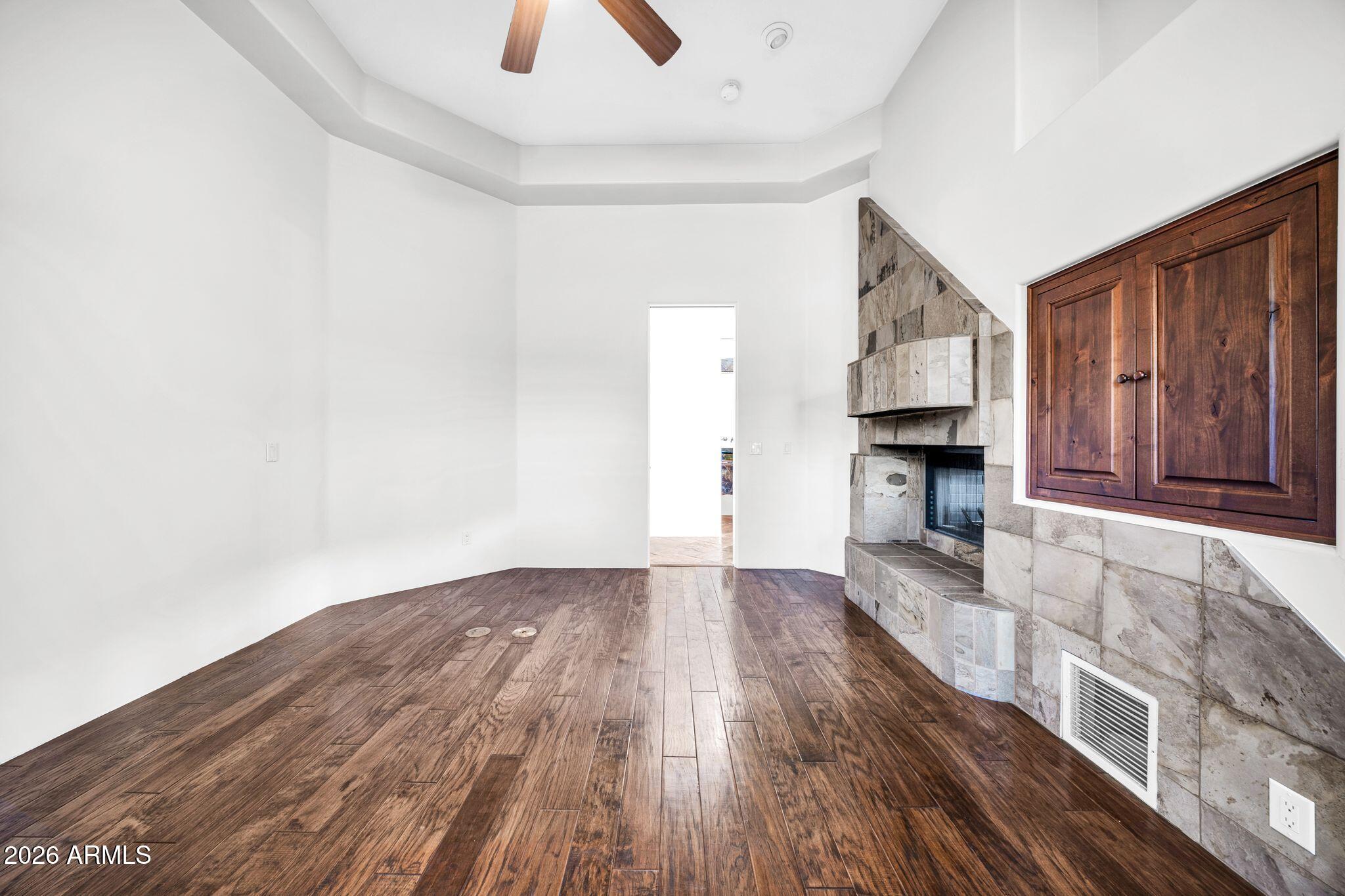 27902 North Agua Verde Drive Rio Verde, AZ 85263 - Photo 25 of 62 an empty room with wooden floor fireplace and windows