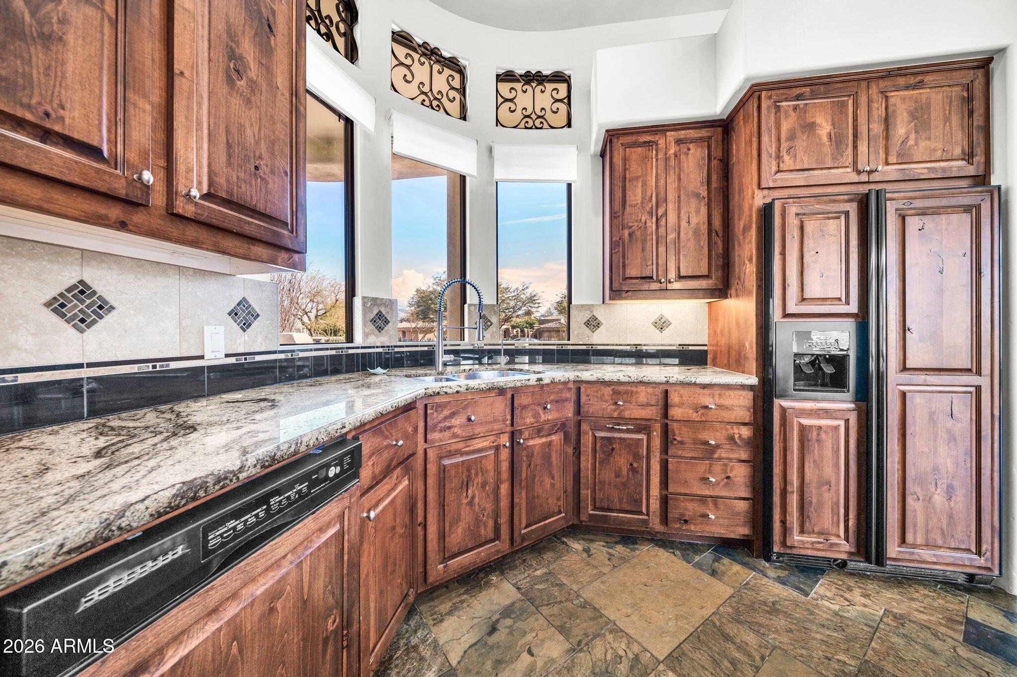27902 North Agua Verde Drive Rio Verde, AZ 85263 - Photo 28 of 62 a kitchen with stainless steel appliances granite countertop a sink and a stove