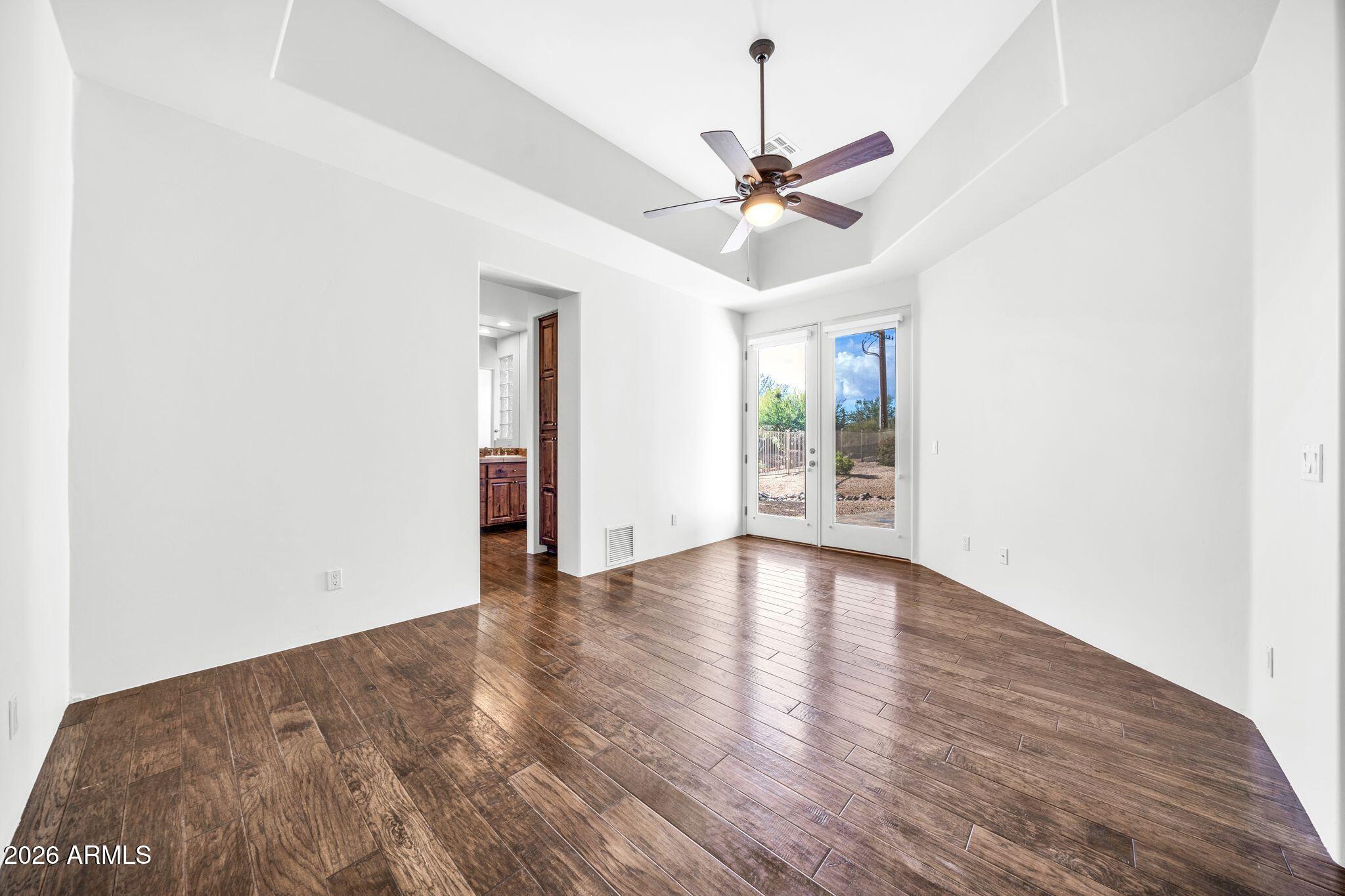 27902 North Agua Verde Drive Rio Verde, AZ 85263 - Photo 46 of 62 a view of an empty room with wooden floor and a window