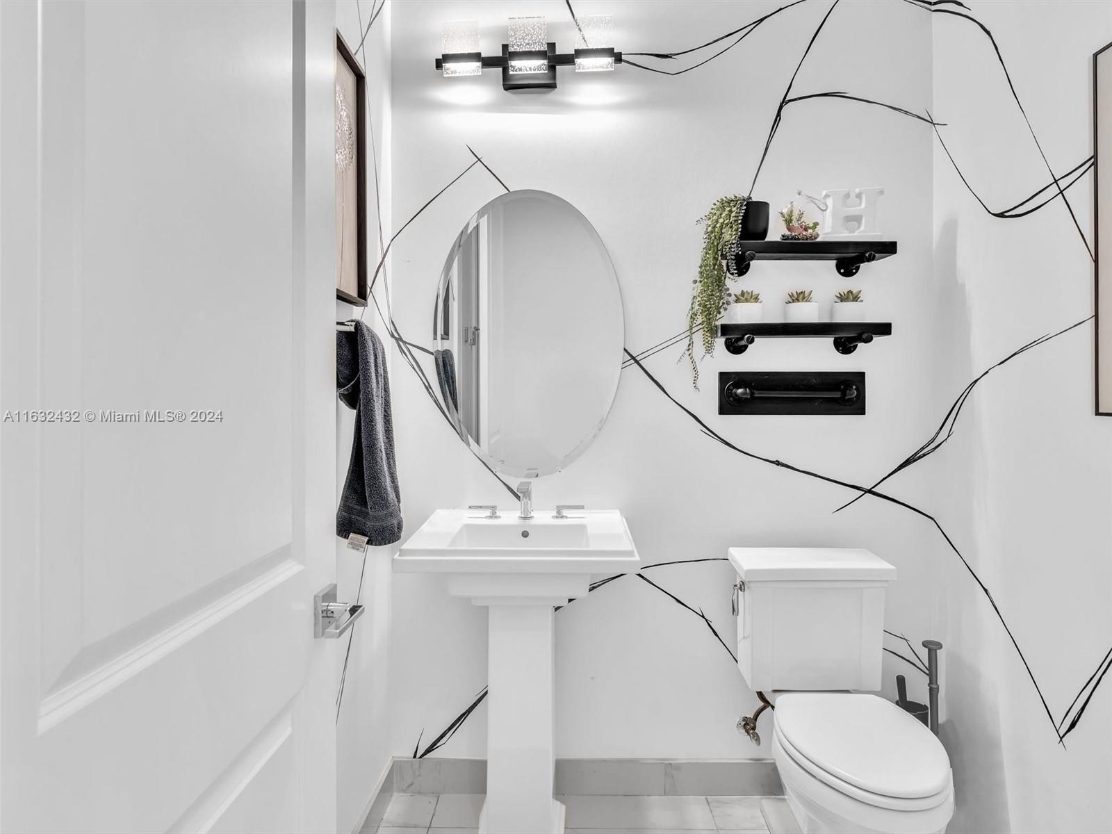 17802 Southwest 58th Street Southwest Ranches, FL 33331 - Photo 33 of 62 a bathroom with a sink a toilet and a mirror