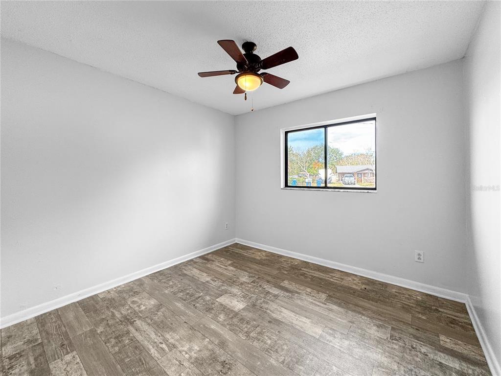 517 3rd Court Southwest Fort Meade, FL 33841 - Photo 19 of 20 a view of empty room with wooden floor and ceiling fan