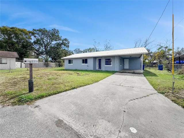 a front view of a house with a garden and yard