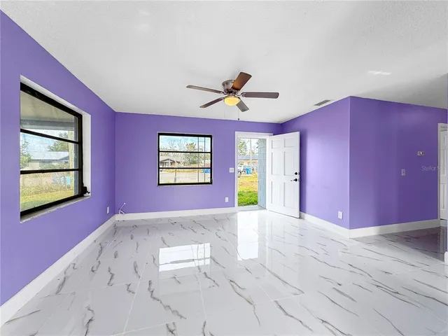 a view of a livingroom with a ceiling fan and window