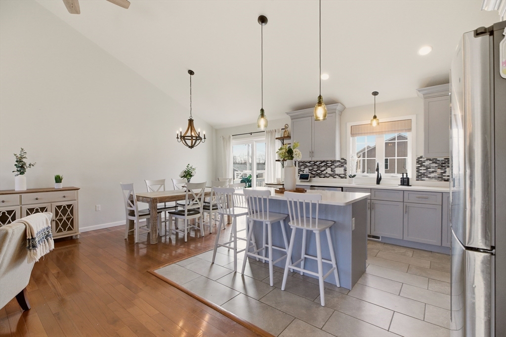 341 Courtney Street Fall River, MA 02720 - Photo 11 of 39 a kitchen with a table chairs sink and cabinets