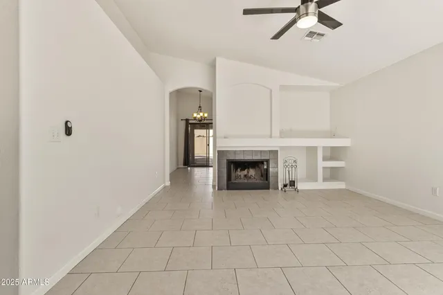 a view of an empty room with a fireplace