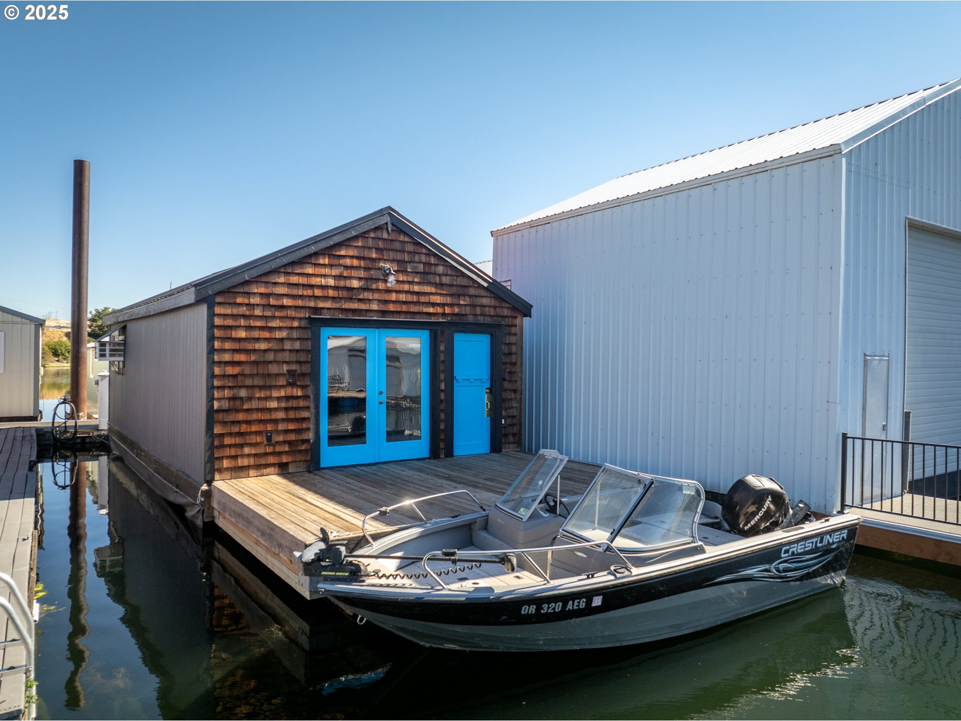a backyard of a house with a table and chairs