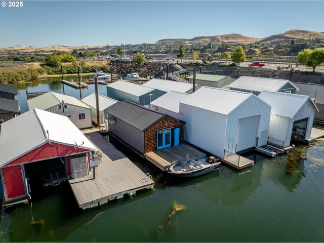 an aerial view of a house with swimming pool and mountains