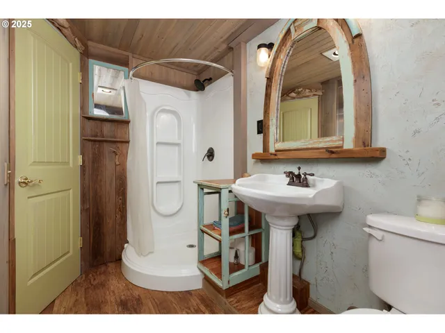 a bathroom with a sink toilet and mirror