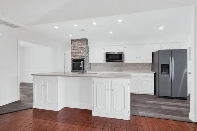 a kitchen with sink and cabinets