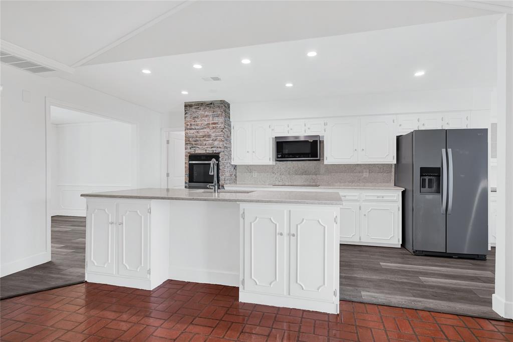 1104 West Lookout Drive Richardson, TX 75080 - Photo 13 of 40 a kitchen with stainless steel appliances granite countertop a refrigerator and a stove top oven