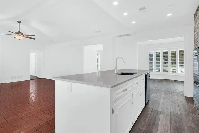 a view of a room with wooden floors and white walls