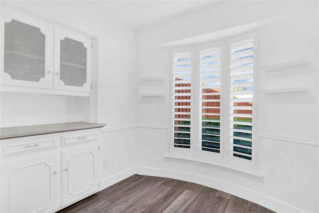 1104 West Lookout Drive Richardson, TX 75080 - Photo 15 of 40 a view of a room with wooden floors and white walls