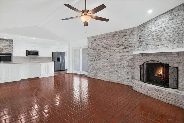 a view of empty room with wooden floor fireplace and windows