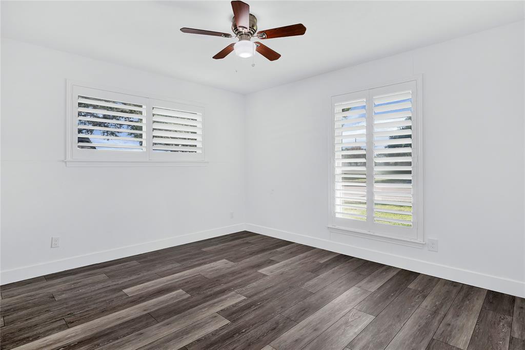 1104 West Lookout Drive Richardson, TX 75080 - Photo 27 of 40 a view of an empty room with wooden floor and a window