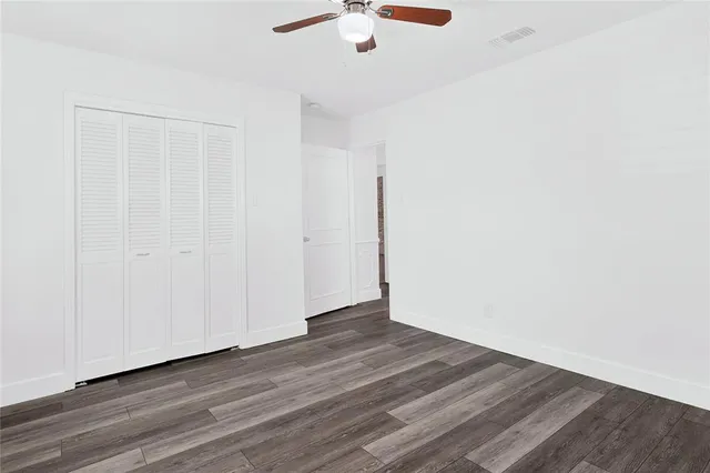 a bathroom with a granite countertop sink a mirror and a bathtub