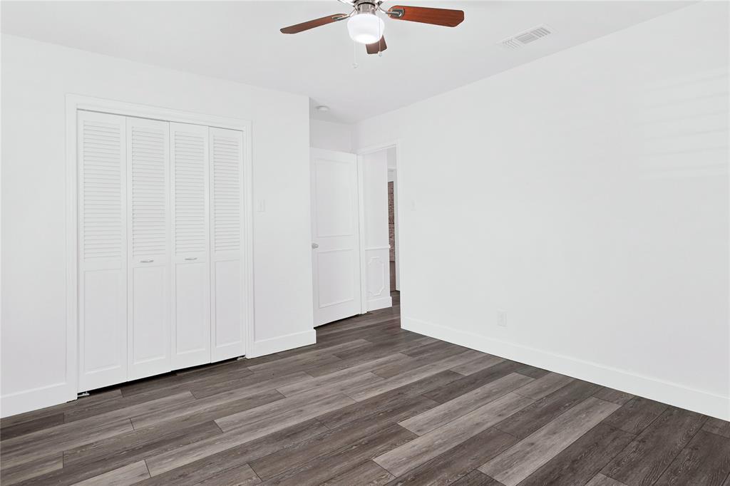1104 West Lookout Drive Richardson, TX 75080 - Photo 28 of 40 a view of an empty room with wooden floor
