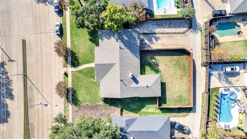 1104 West Lookout Drive Richardson, TX 75080 - Photo 3 of 40 an aerial view of a house with a yard fountain and a large tree