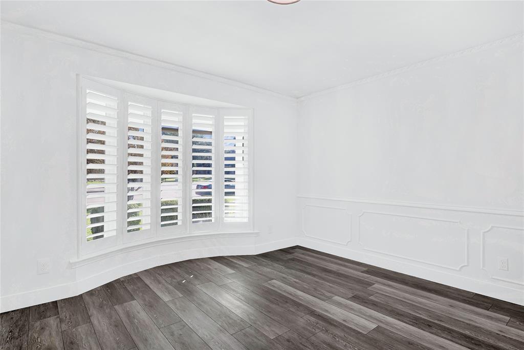 1104 West Lookout Drive Richardson, TX 75080 - Photo 9 of 40 a view of an empty room with wooden floor and a window