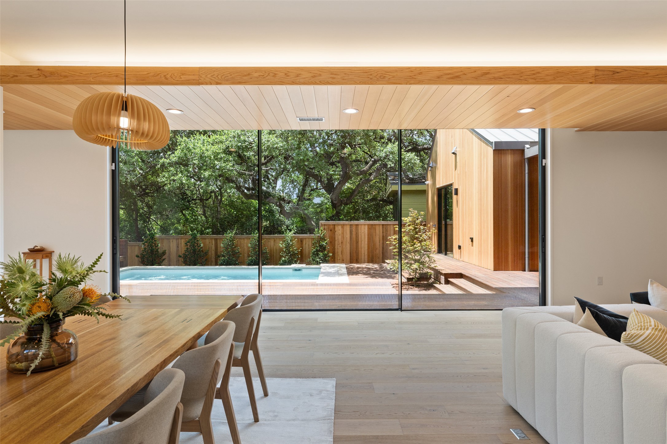Dining space with floor to ceiling windows, wood finished floors, recessed lighting, and wood ceiling