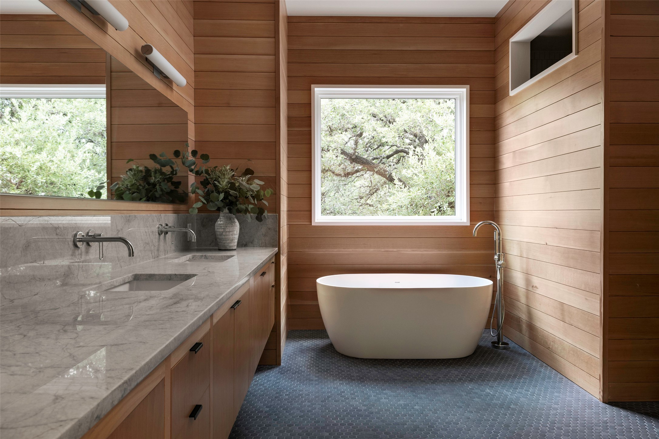 1319 Bonham Terrace Austin, TX 78704 - Photo 16 of 24 Bathroom featuring wood walls, a freestanding tub, and double vanity