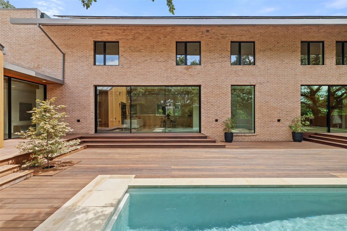 1319 Bonham Terrace Austin, TX 78704 - Photo 22 of 24 Rear view of house with a wooden deck, an outdoor pool, and brick siding