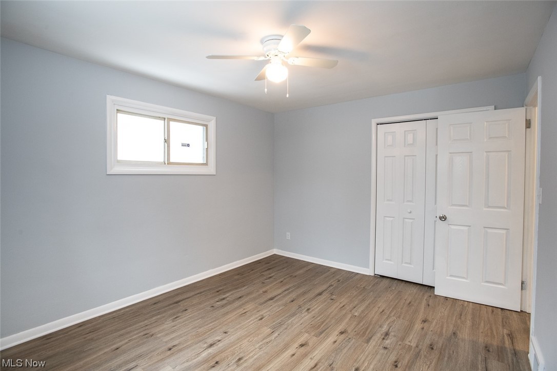 208 Greenvale Road Cleveland, OH 44121 - Photo 17 of 33 Unfurnished bedroom with light hardwood / wood-style flooring, a closet, and ceiling fan