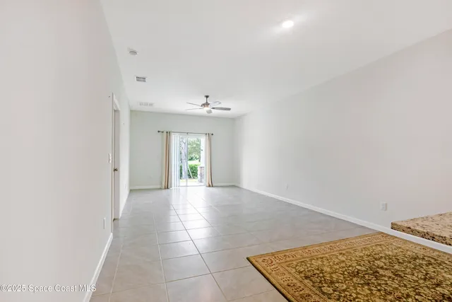 an empty room with kitchen and window
