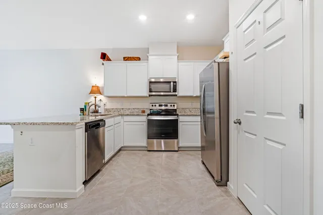a kitchen with a refrigerator and a stove
