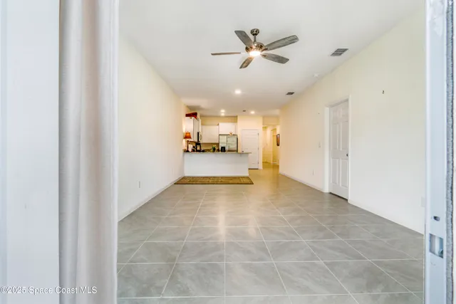 a view of a livingroom with furniture and a ceiling fan