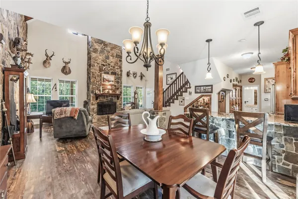 a kitchen with stainless steel appliances granite countertop a refrigerator a stove and a wooden floors