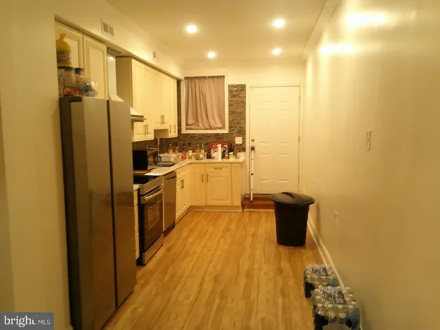 a kitchen with a refrigerator and a sink