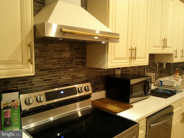 a kitchen with a stove and a microwave