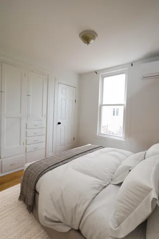 a room with a bed and a dresser