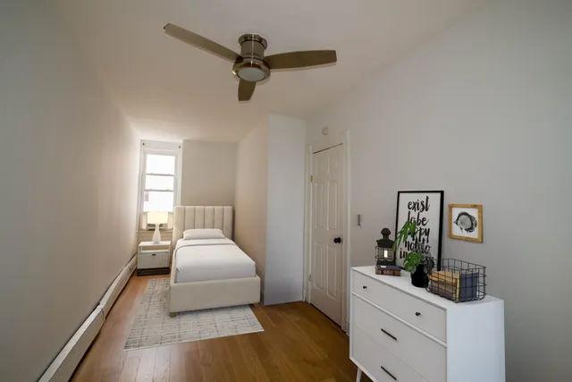 a bedroom with a bed furniture and windows