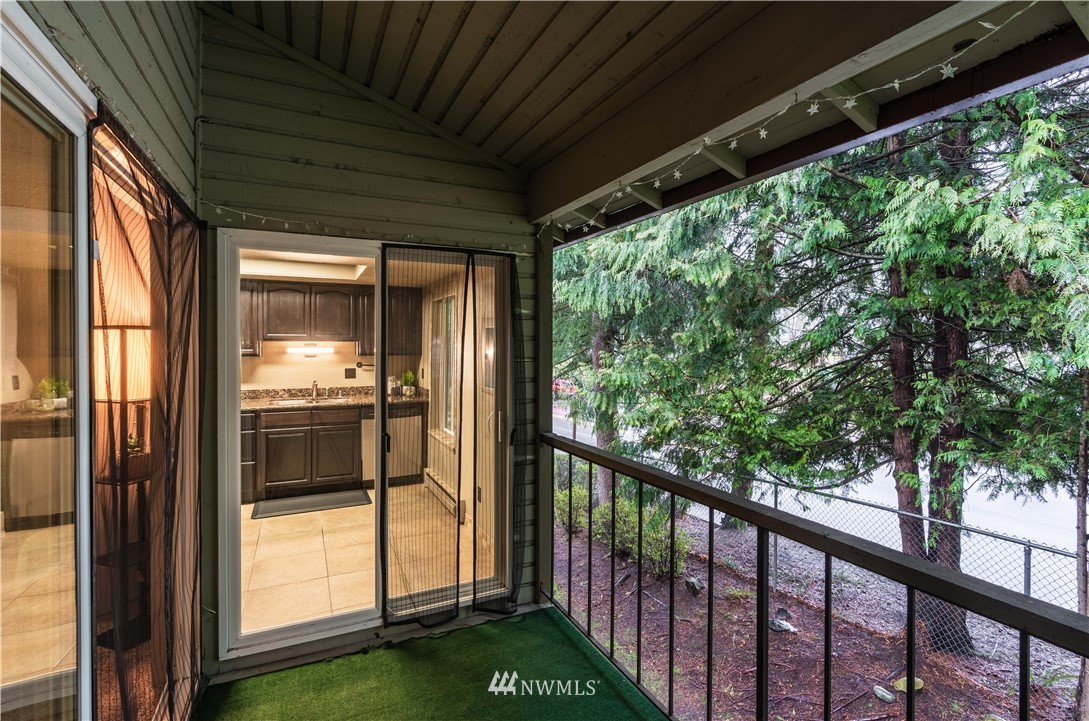 17537 151st Avenue Southeast, Unit 98 Renton, WA 98058 - Photo 15 of 19 a view of backyard with large trees and wooden fence